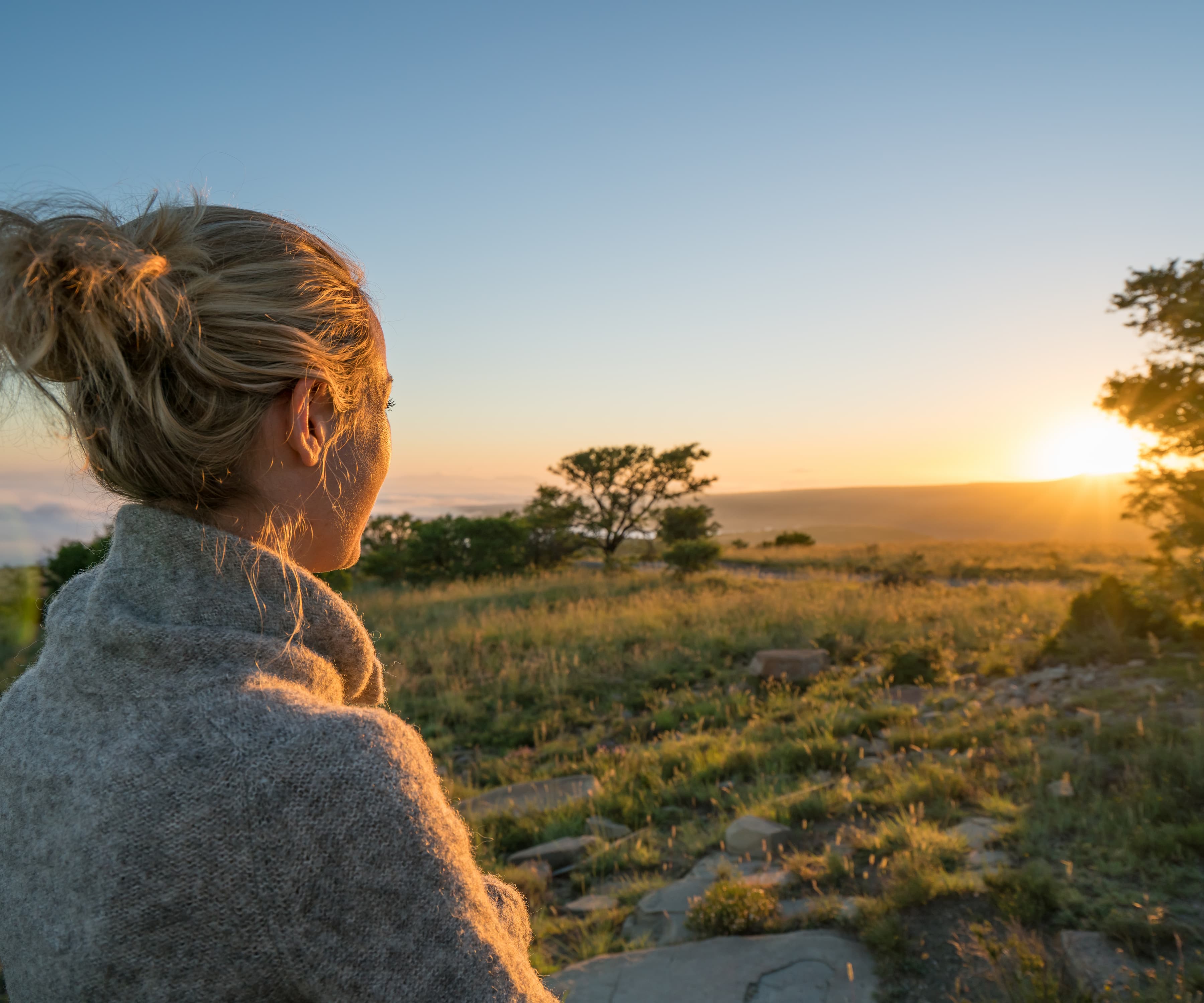 Coaching existentiel - Une femme face à un soleil couchant